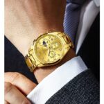 Luxury gold watch paired with formal black suit and white shirt, worn on wrist for business style